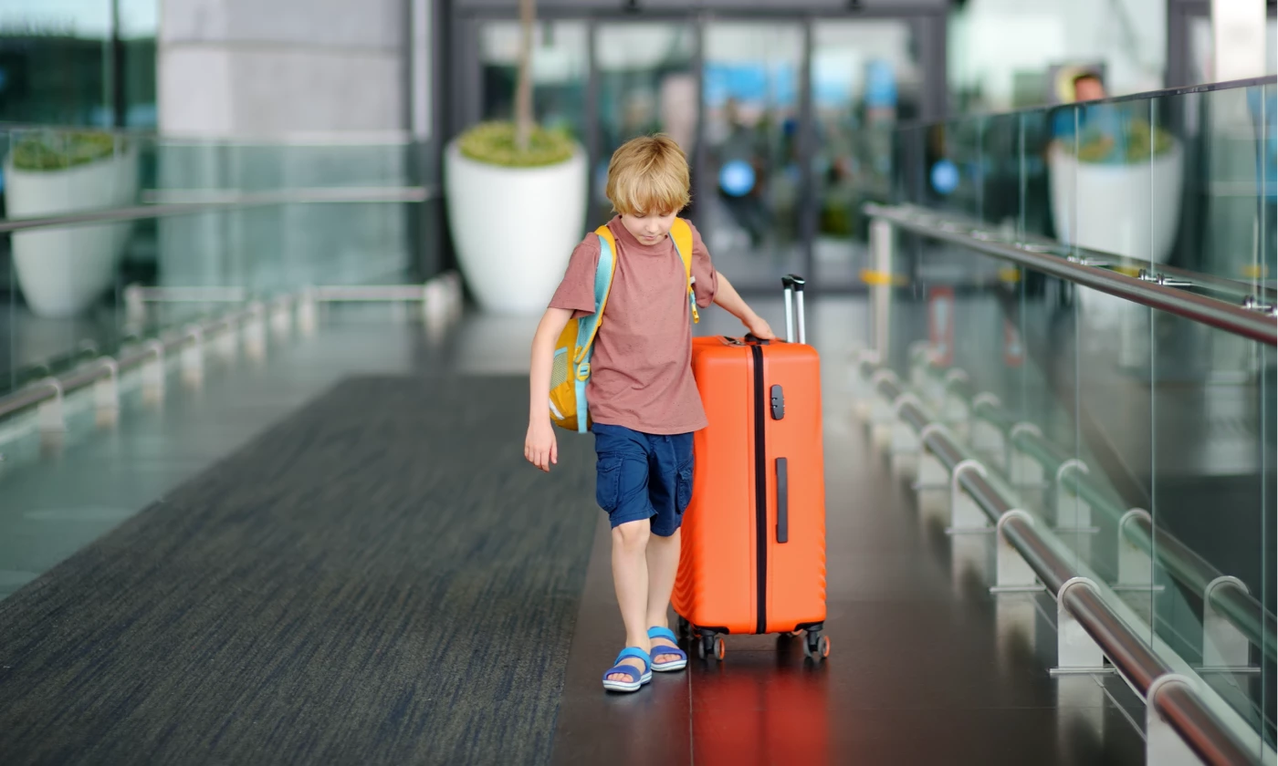 Child with suitcase travelling