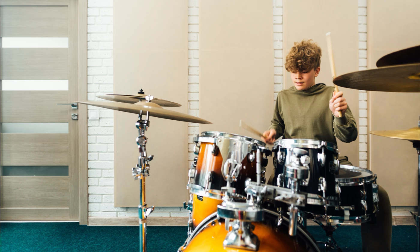 young boy playing drums